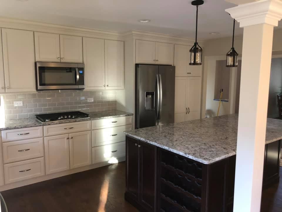 A & R Home Services  kitchen with white cabinets and granite counter tops