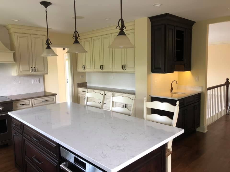 A & R Home Services  kitchen with a large island and white counter tops