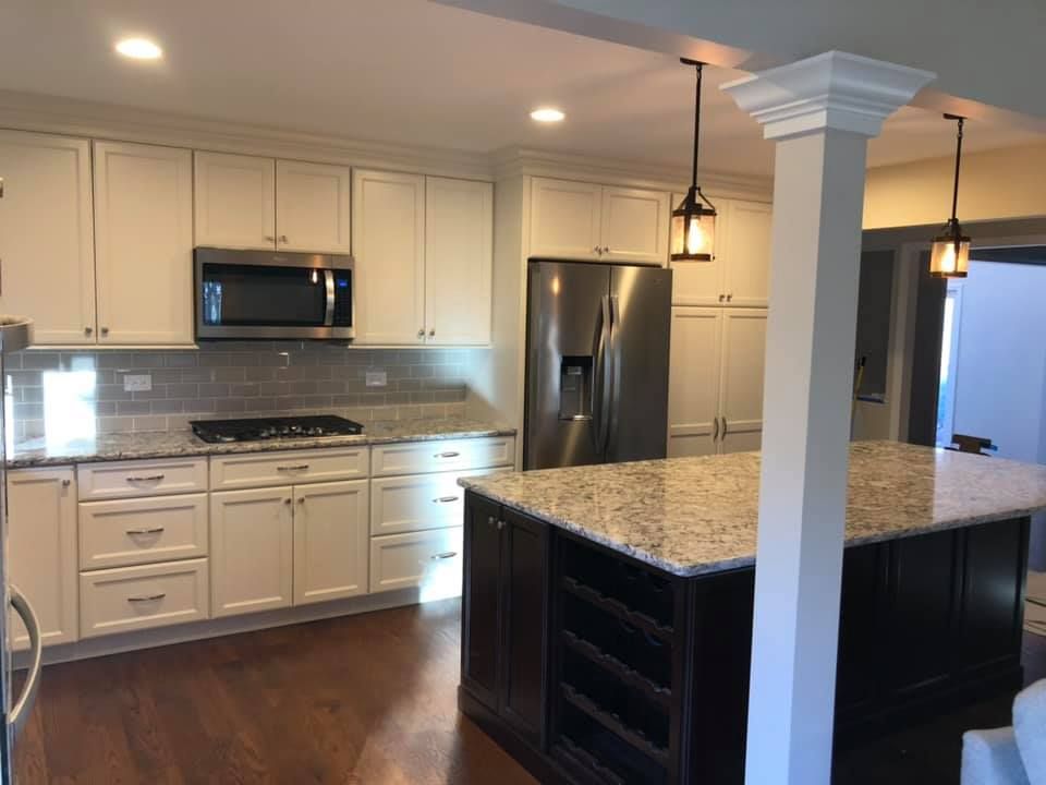 A & R Home Services remodel kitchen with white cabinets and granite counter tops