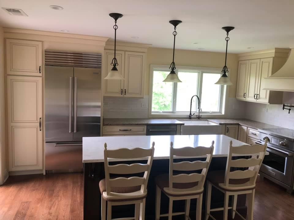 A & R Home Services remodel  kitchen with white cabinets and stainless steel appliances