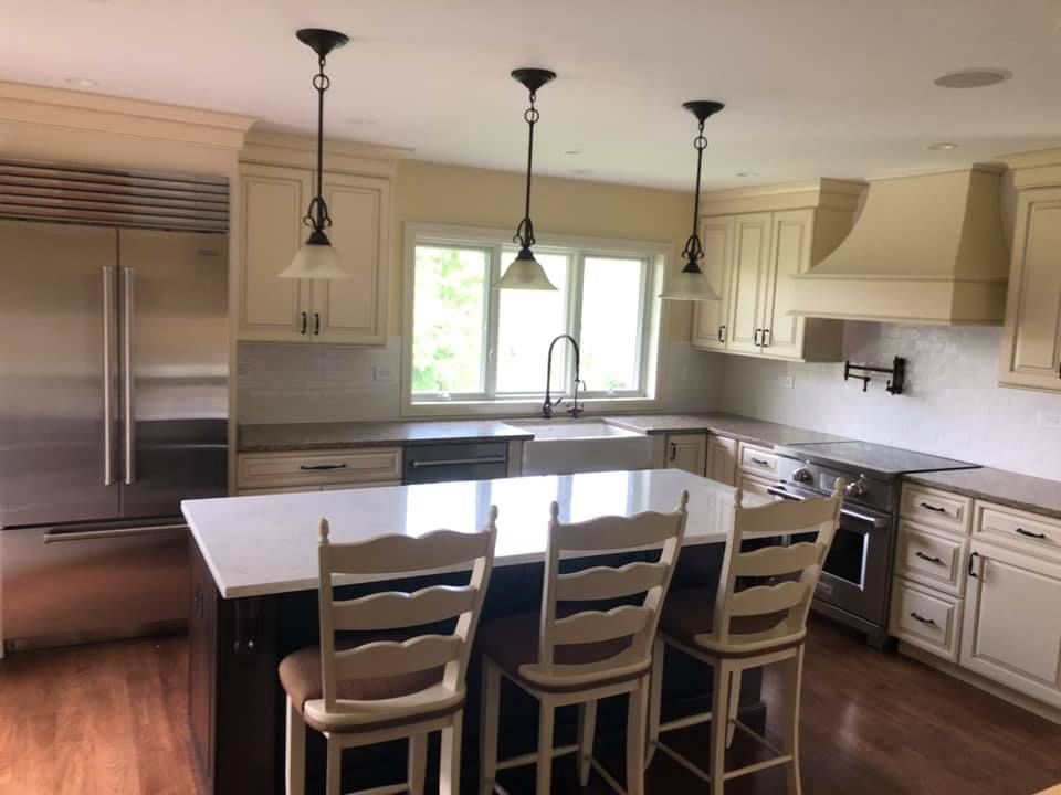 A & R Home Services remodel  kitchen with white cabinets and stainless steel appliances