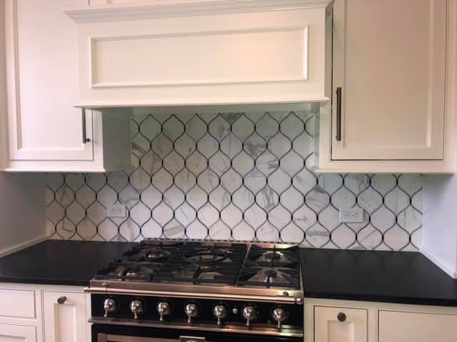 A & R Home Services kitchen with a stove top oven and white cabinets