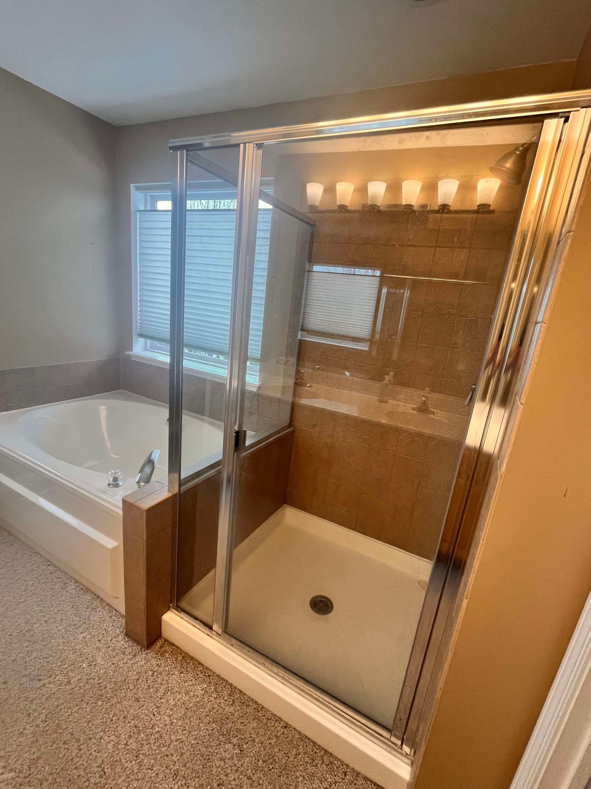 A & R Home Services remodel  bathroom with a bathtub and a walk in shower.