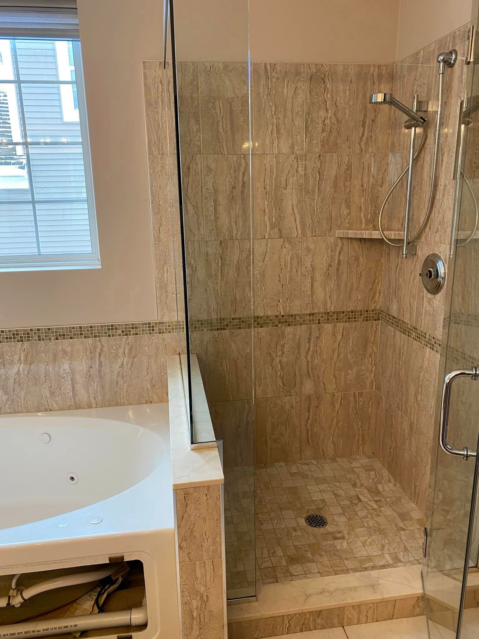 A & R Home Services remodel  bathroom with a tub and a walk in shower.