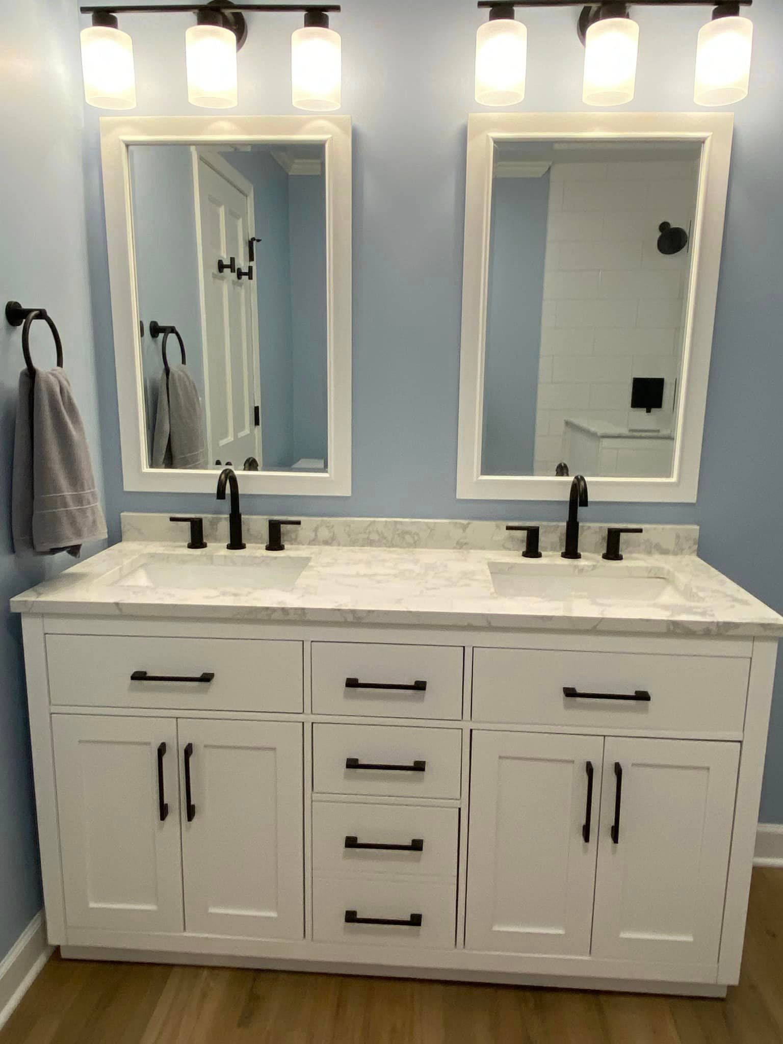 A & R Home Services remodel bathroom with two sinks and two mirrors.