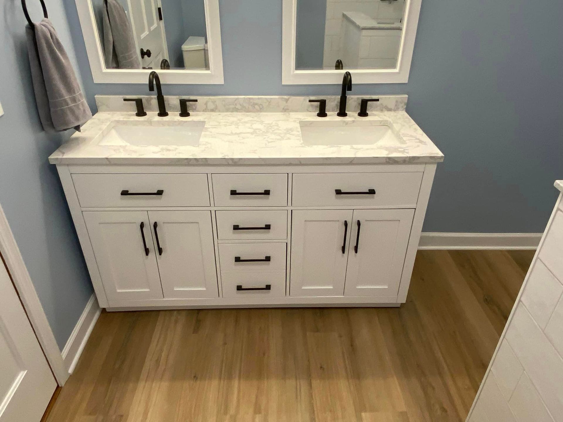 A & R Home Services remodel bathroom with two sinks and two mirrors.