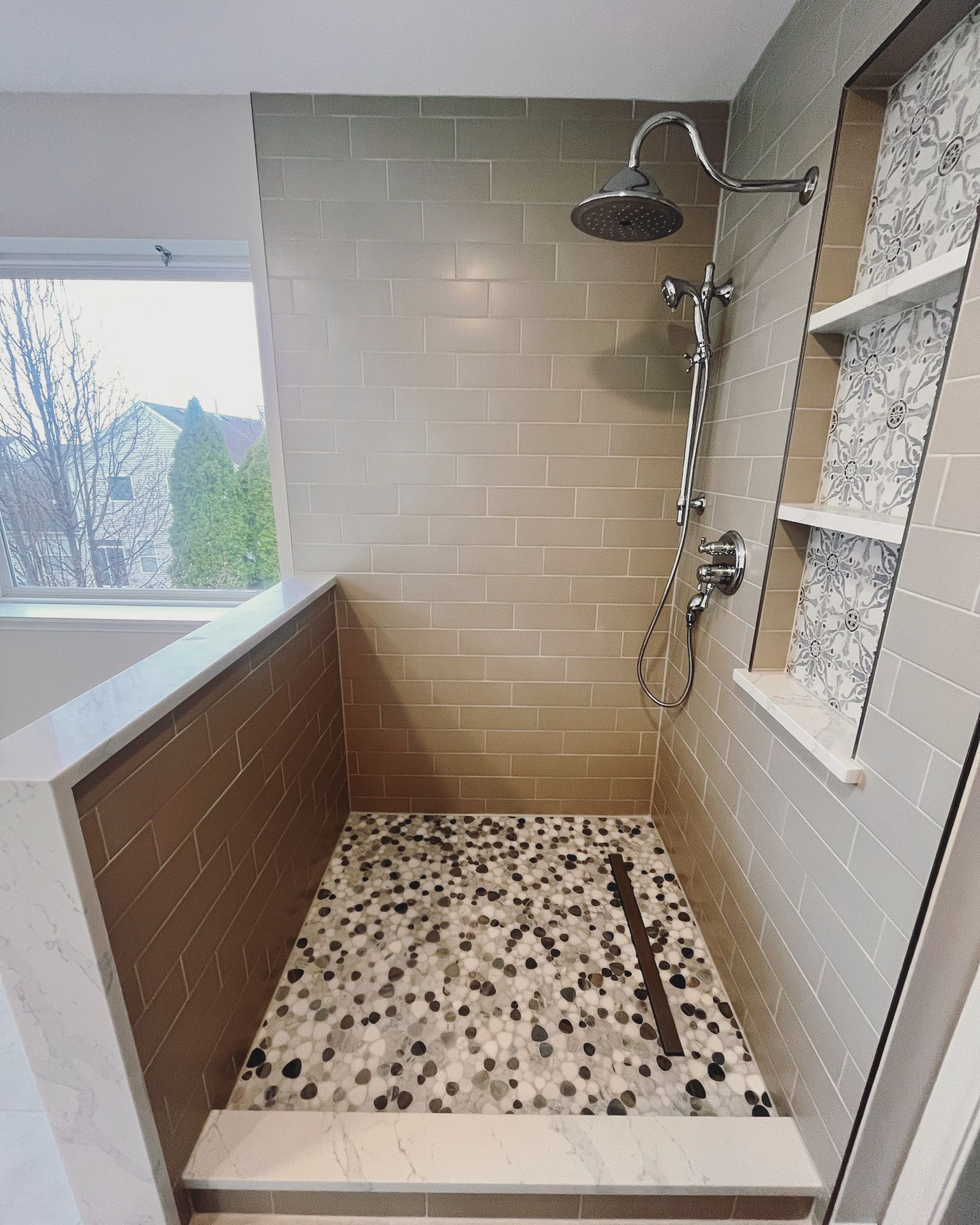 A & R Home Services remodel  bathroom with a walk in shower and a window.