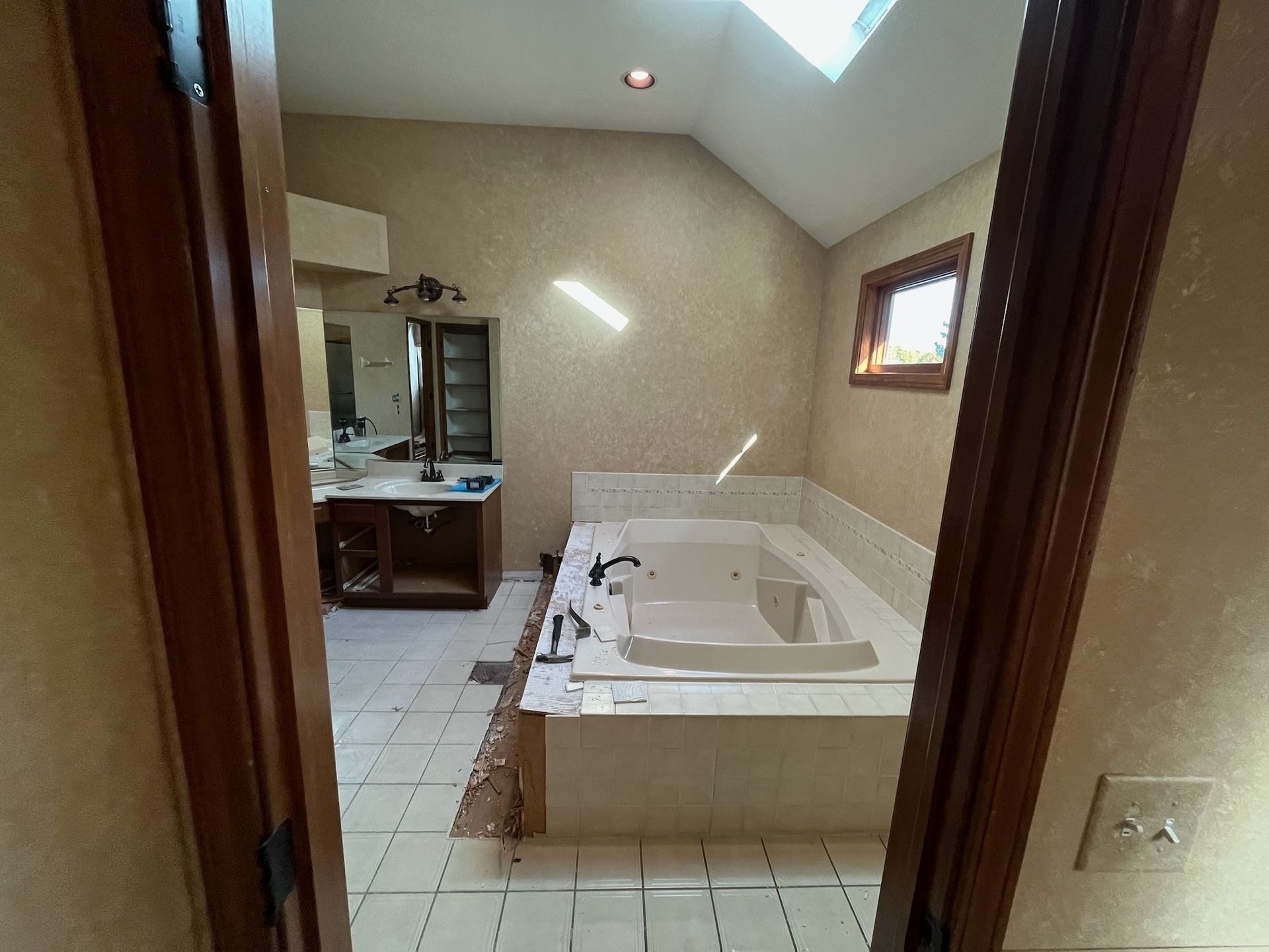 A & R Home Services remodel bathroom with a jacuzzi tub and a skylight