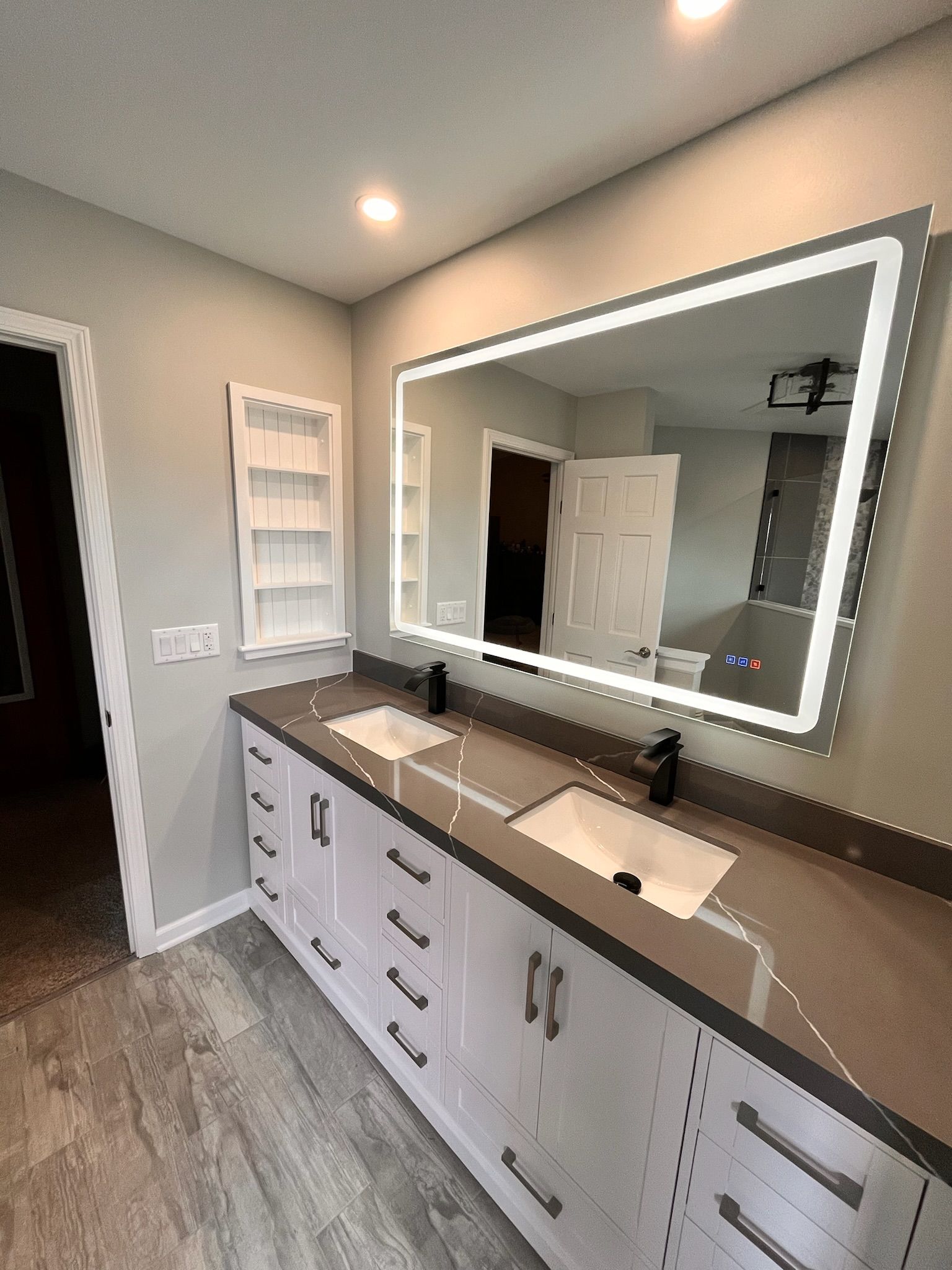 A & R Home Services remodel  bathroom with two sinks and a large mirror.