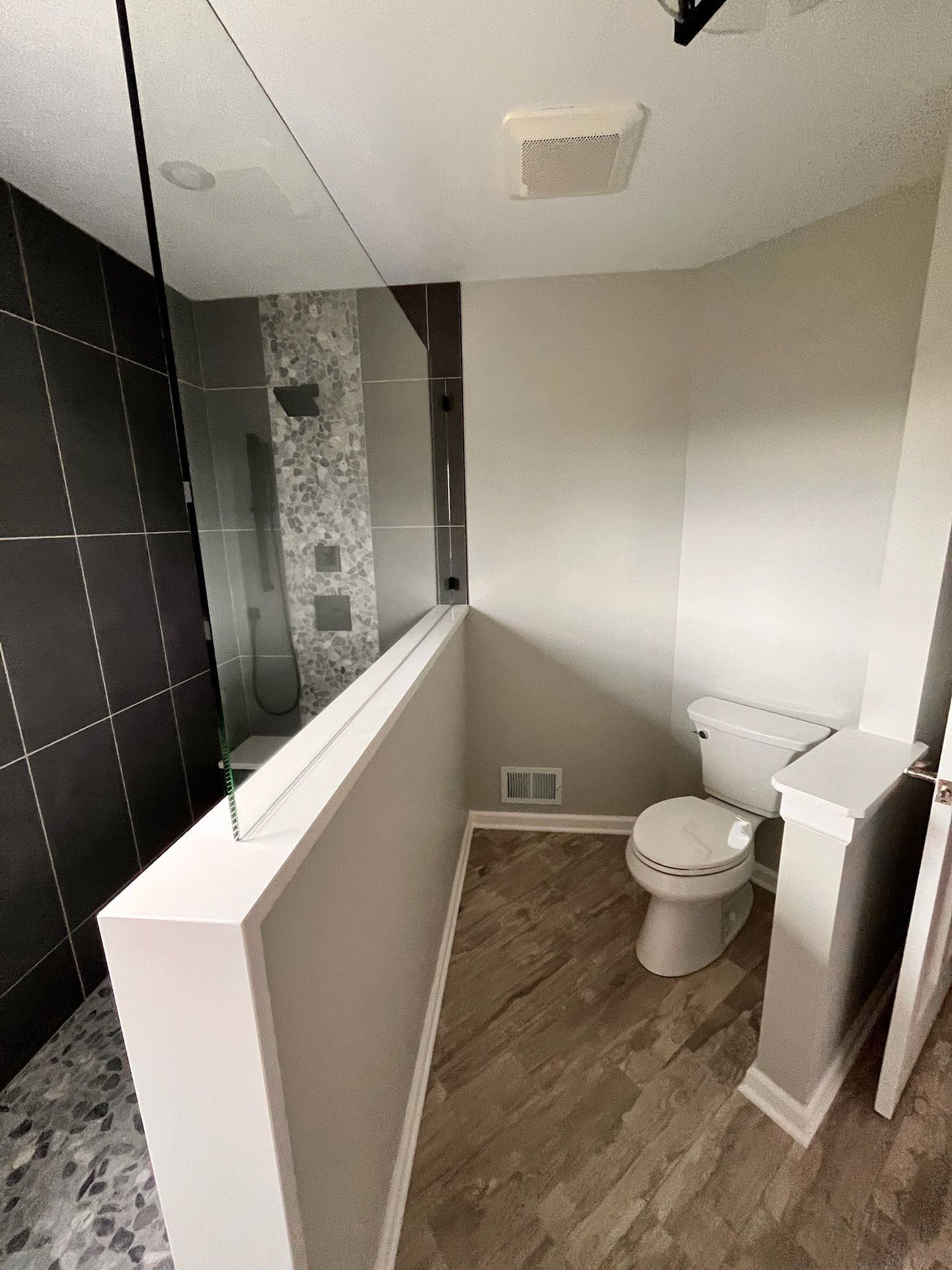 A & R Home Services remodel bathroom with a toilet and a walk in shower.