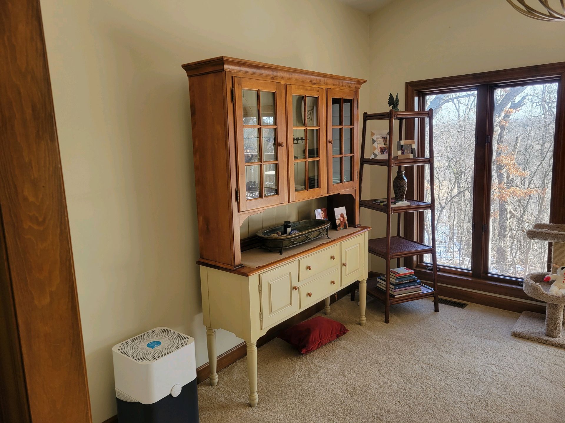 A & R Home Services remodel living room with a hutch , shelf , chair and trash can.