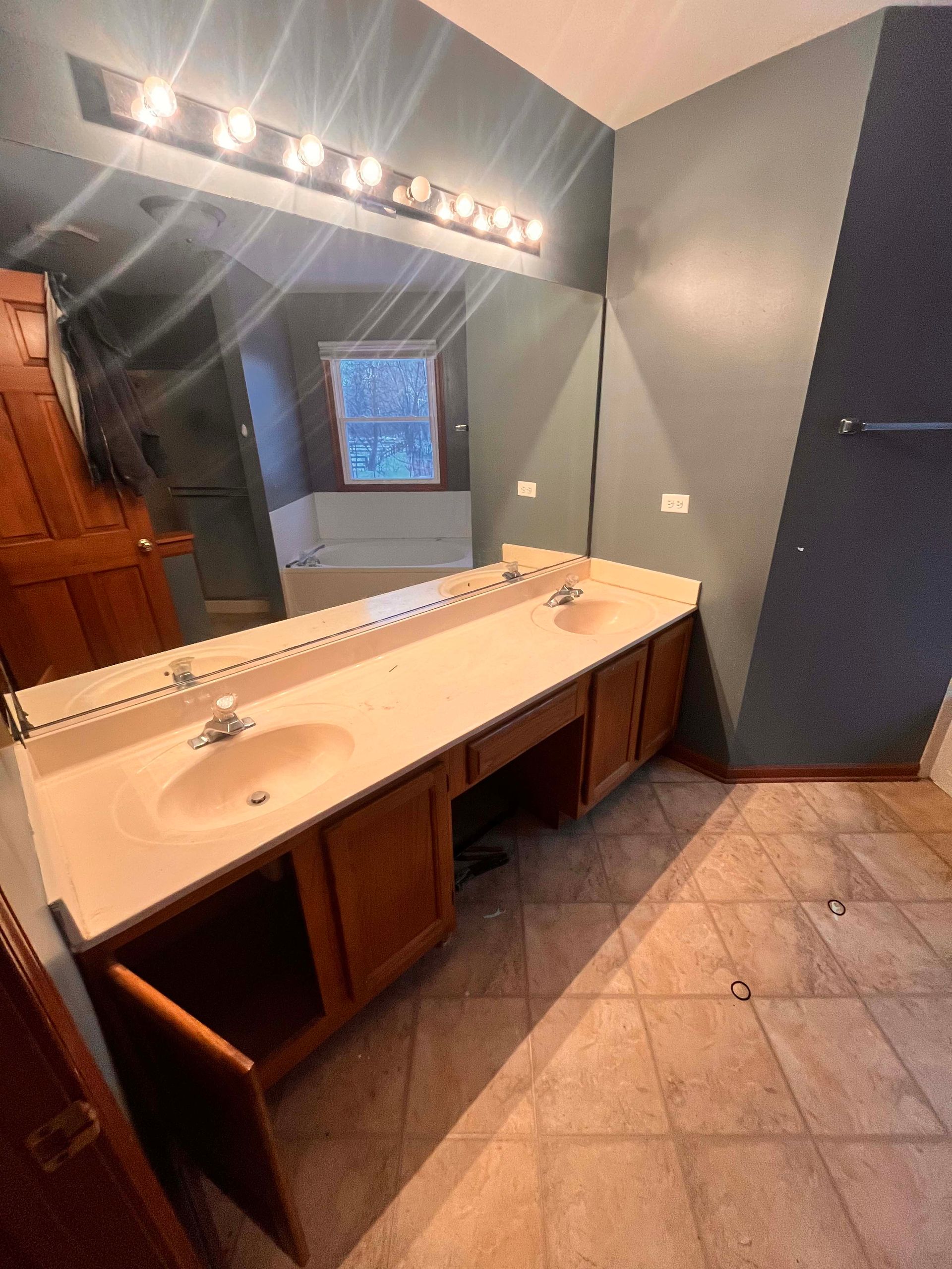 A & R Home Services remodel bathroom with two sinks and a large mirror