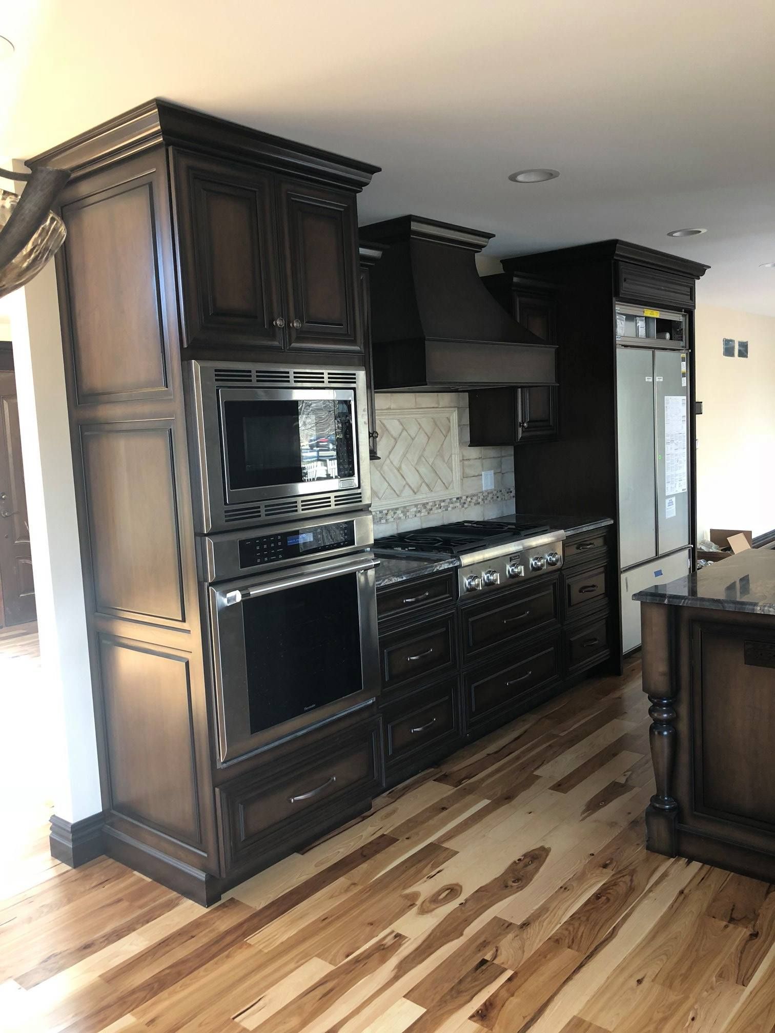 A & R Home Services  kitchen with hardwood floors and stainless steel appliances.