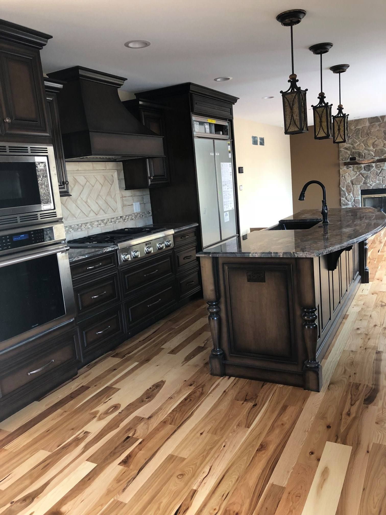 A & R Home Services kitchen with hardwood floors and stainless steel appliances.