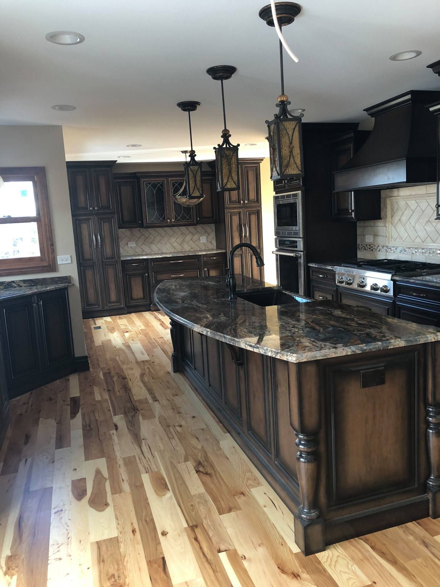 A & R Home Services  kitchen with hardwood floors and a large island