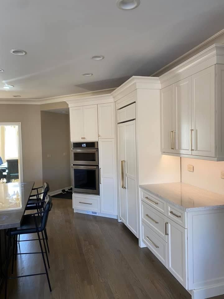 A & R Home Services kitchen with white cabinets and stainless steel appliances