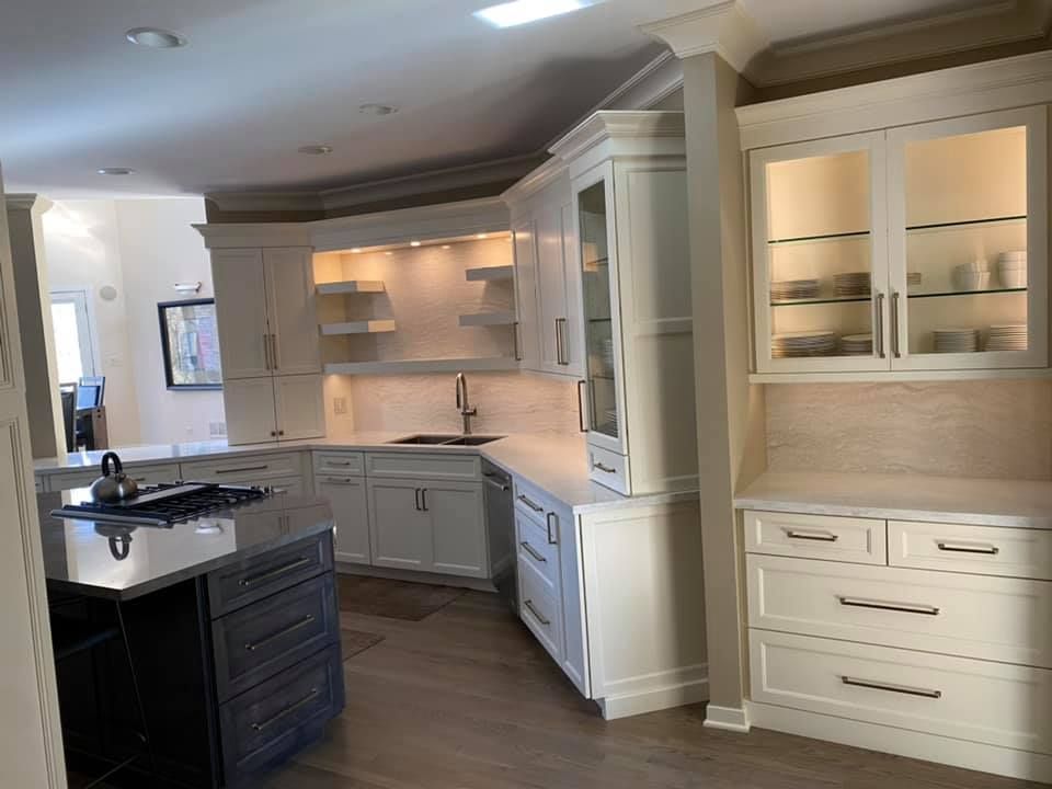 A & R Home Services  kitchen with white cabinets , a sink , and a stove top oven.