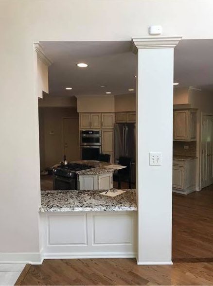 A & R Home Services kitchen with a pillar between the kitchen and the living room.