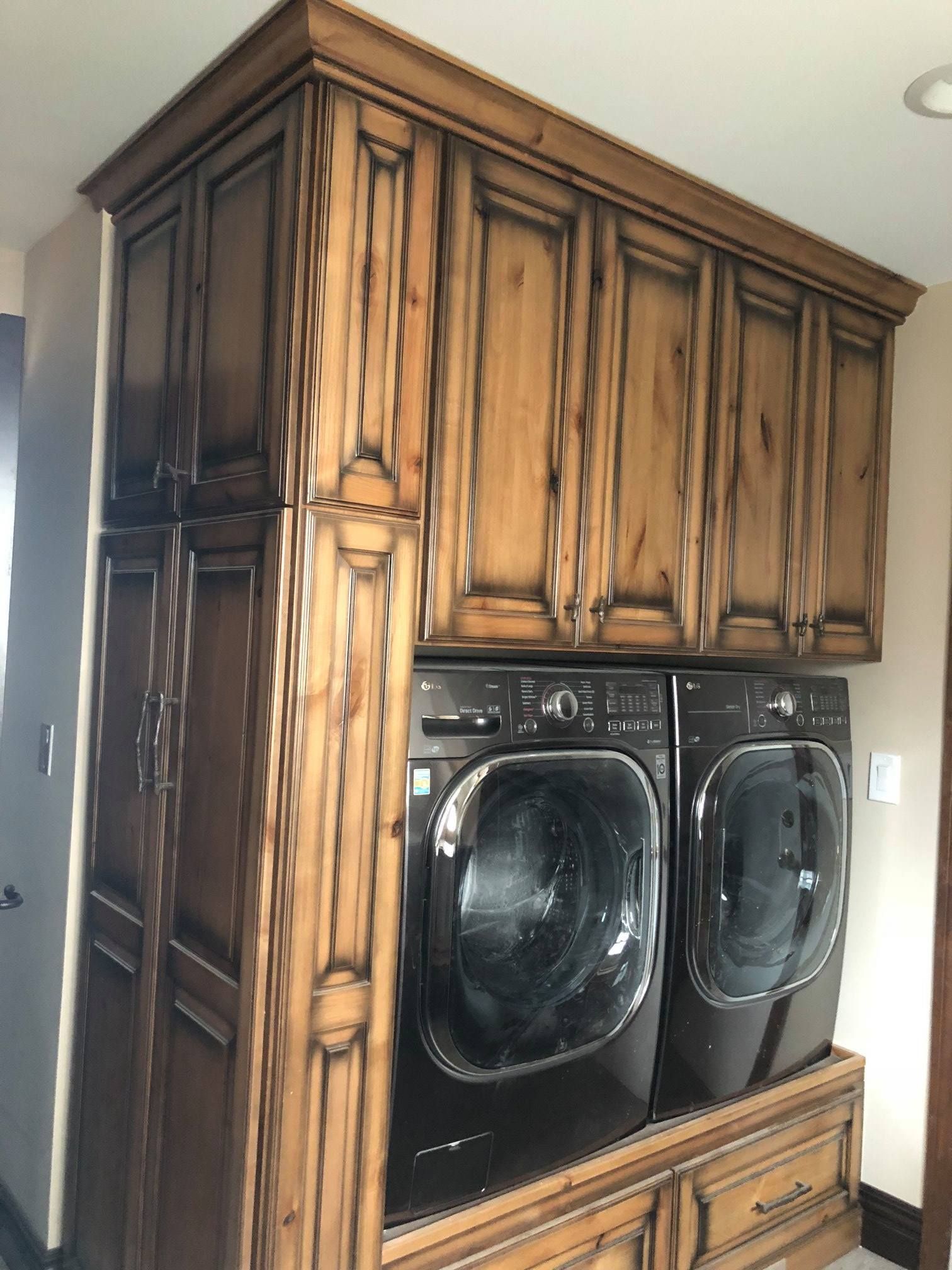 A & R Home Services remodel laundry room with wooden cabinets and a washer and dryer