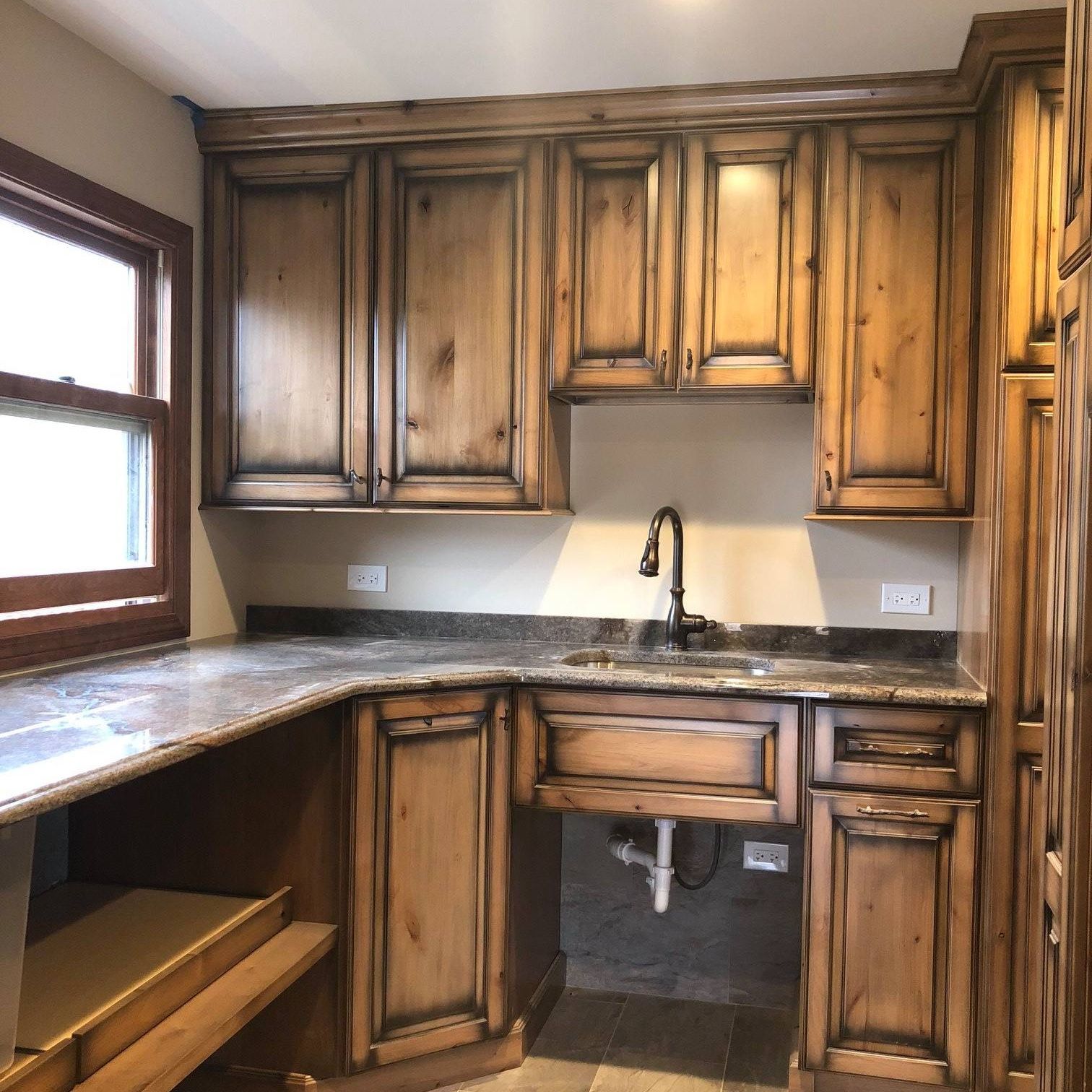 A & R Home Services remodel kitchen with wooden cabinets and granite counter tops