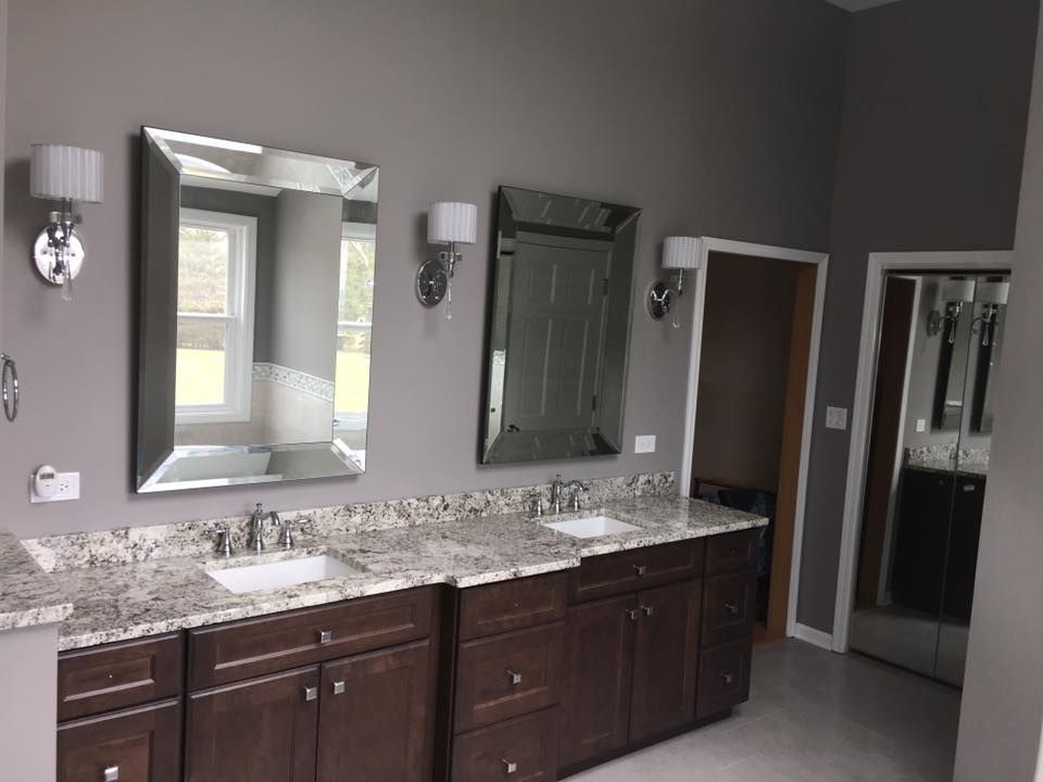 A & R Home Services remodel bathroom with two sinks and two mirrors.
