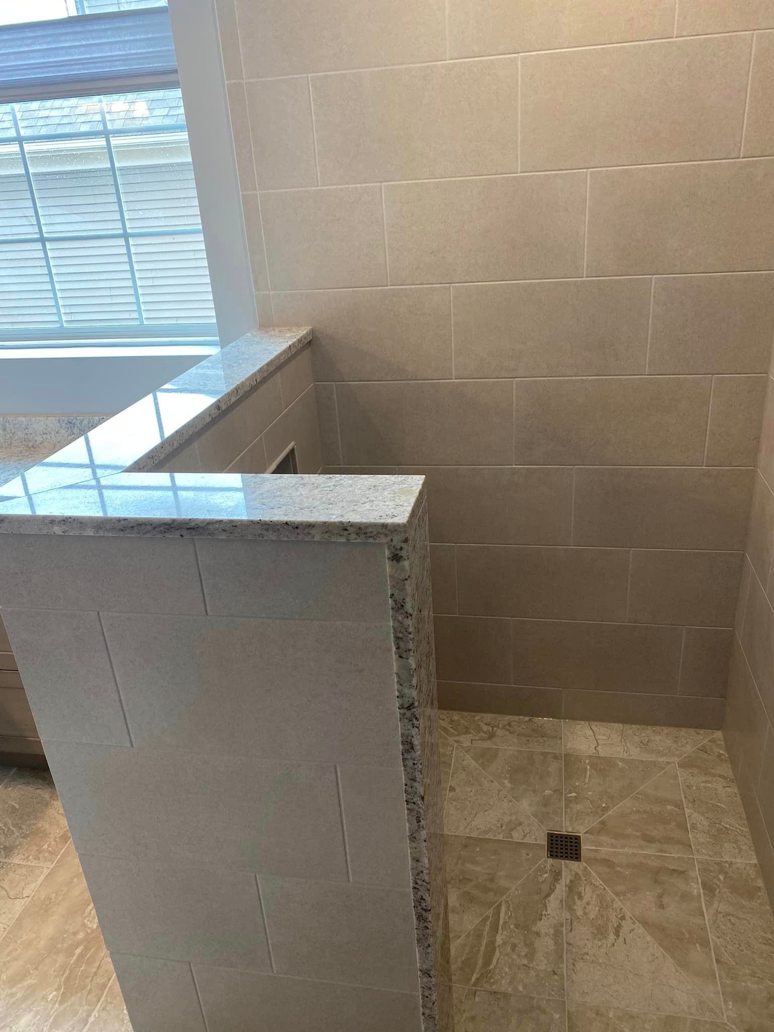 A & R Home Services remodel bathroom with a walk in shower and a window.