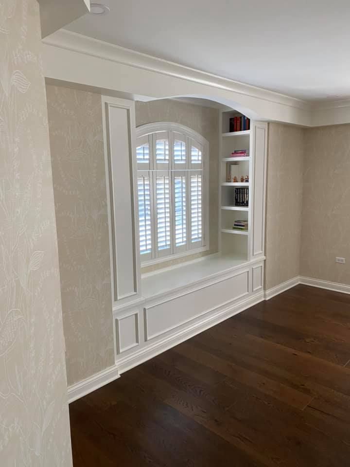 A & R Home Services remodel living room with a window seat and shelves.