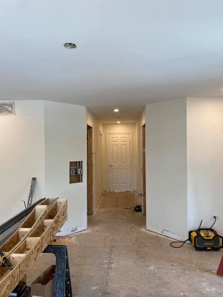 A & R Home Services remodel room with white walls and wooden floors is being remodeled.