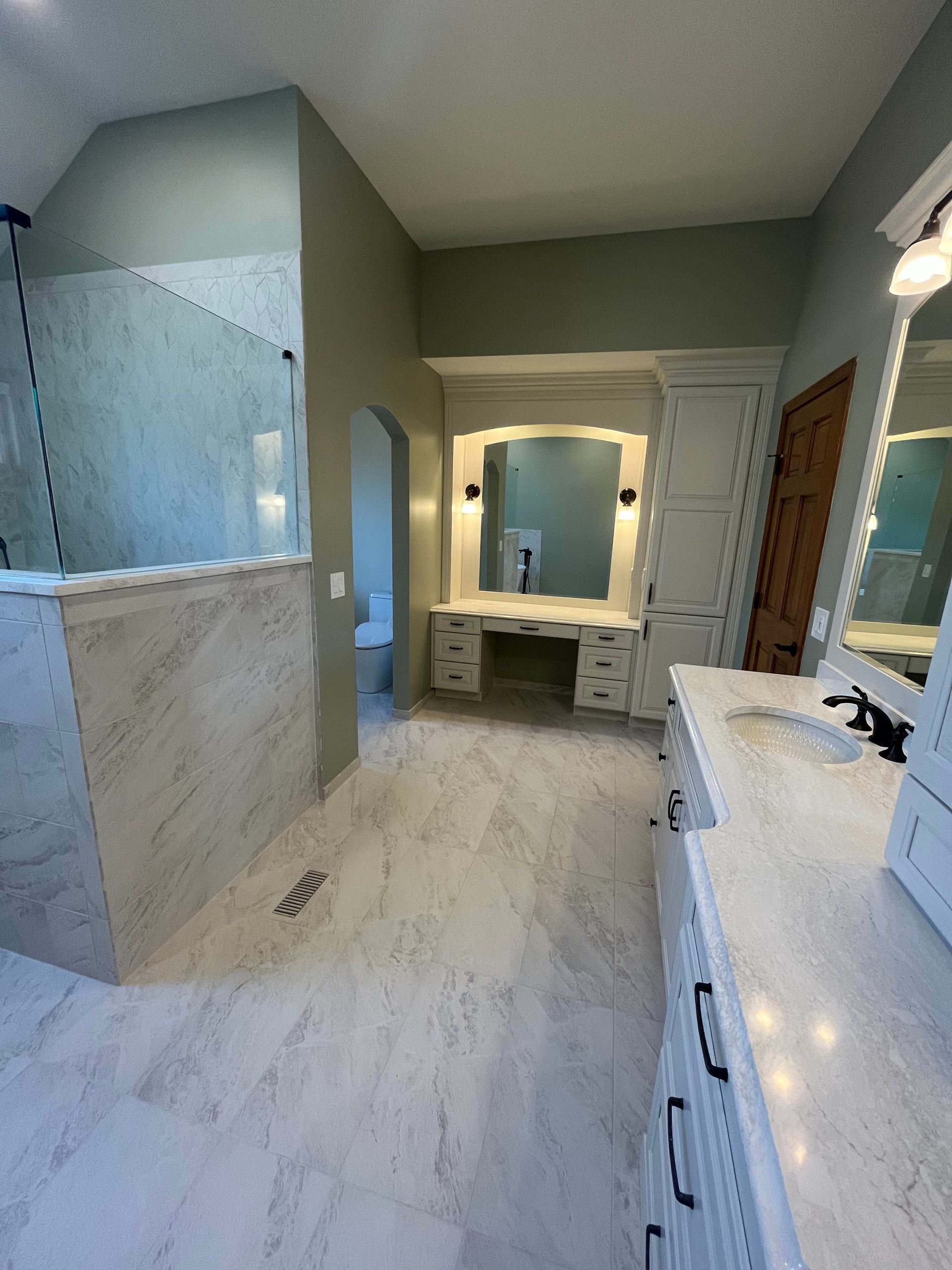 A & R Home Services remodel bathroom with two sinks , a mirror and a walk in shower.