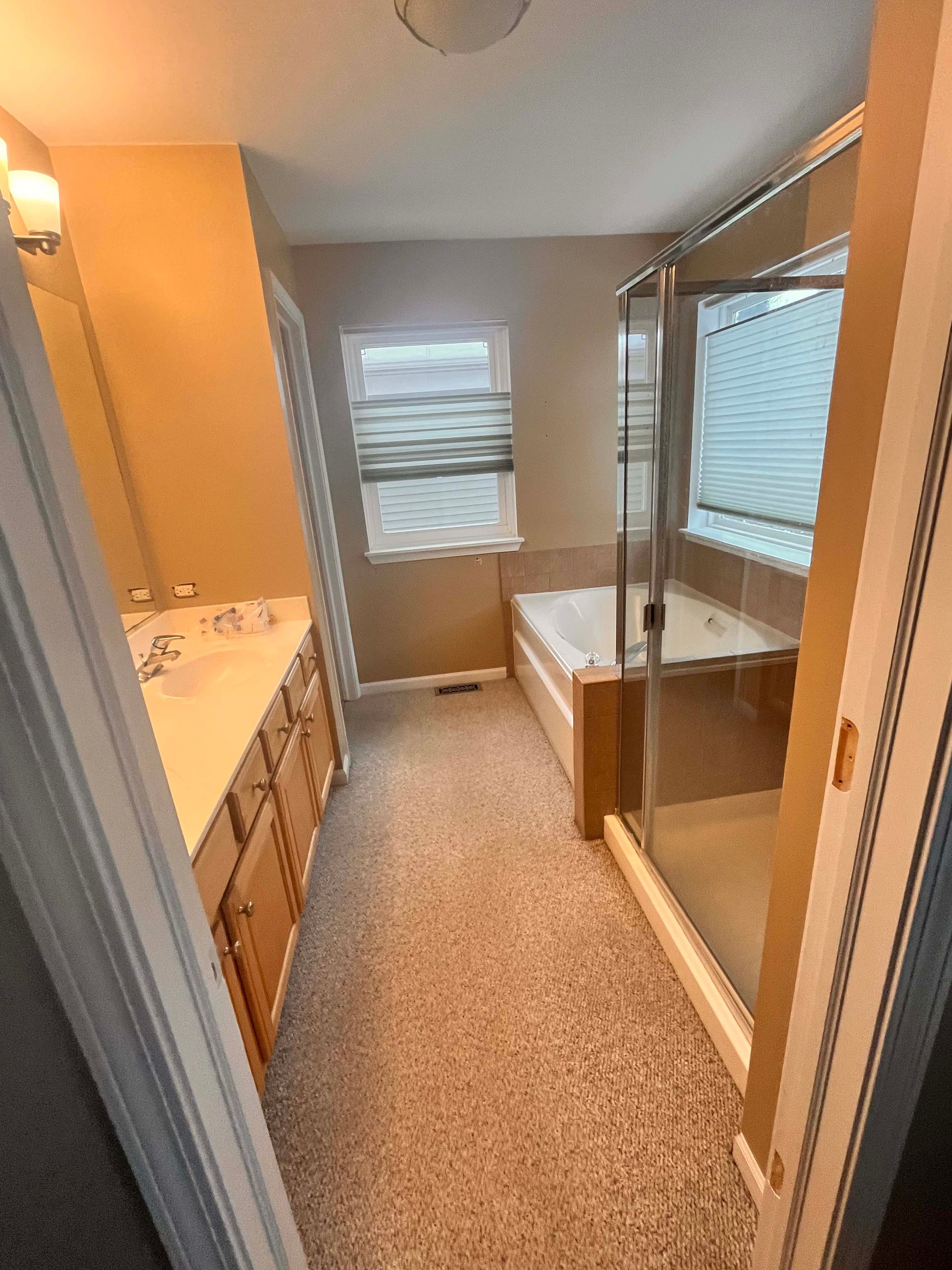 A & R Home Services remodel  bathroom with two sinks , a tub , and a walk in shower.