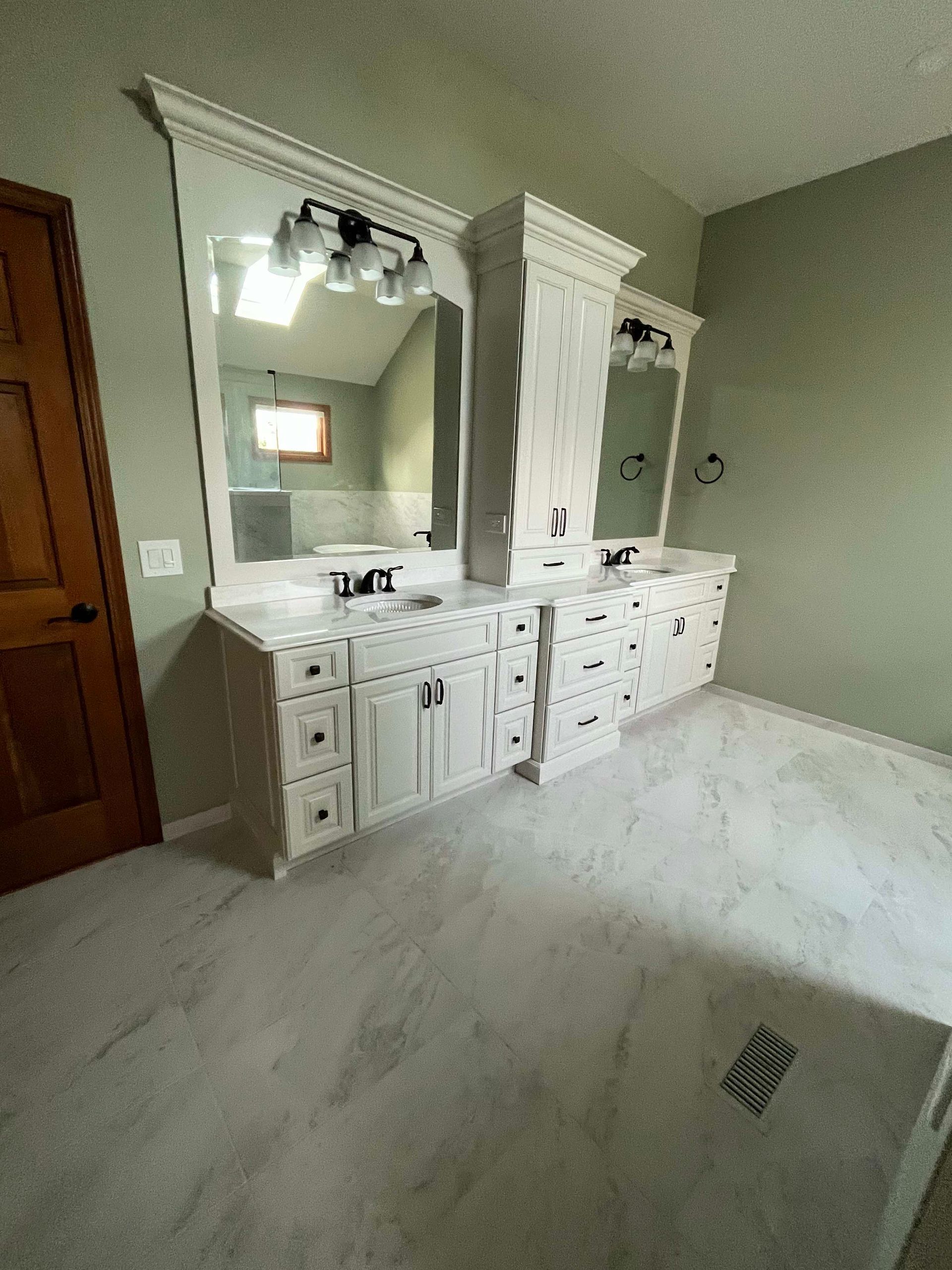 A & R Home Services remodel bathroom with two sinks and two mirrors.