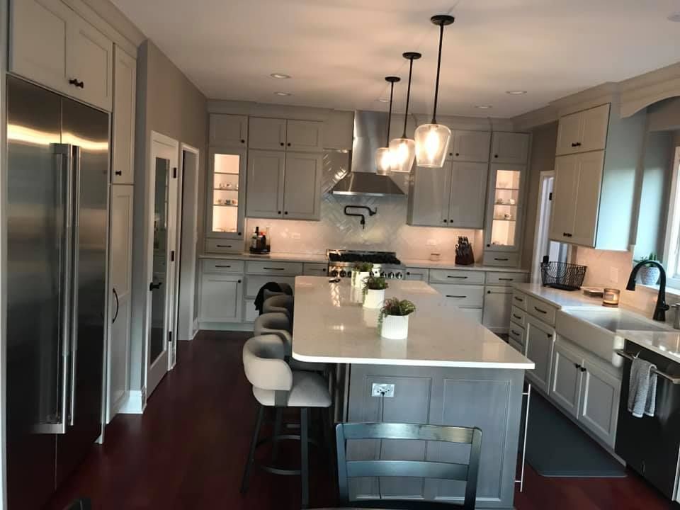 A & R Home Services remodel kitchen with white cabinets and stainless steel appliances