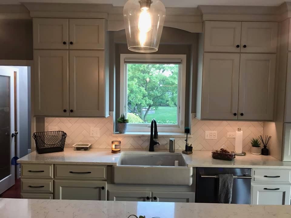 A & R Home Services remodel kitchen with a sink and a window with custom lighting 