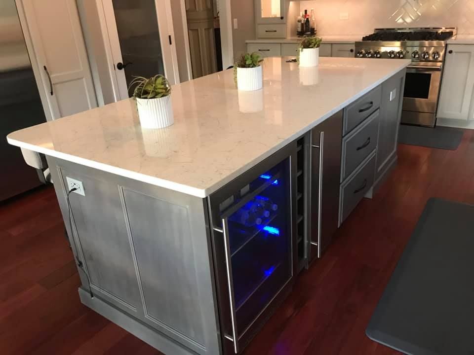 A & R Home Services remodel kitchen with a large island and a wine cooler.