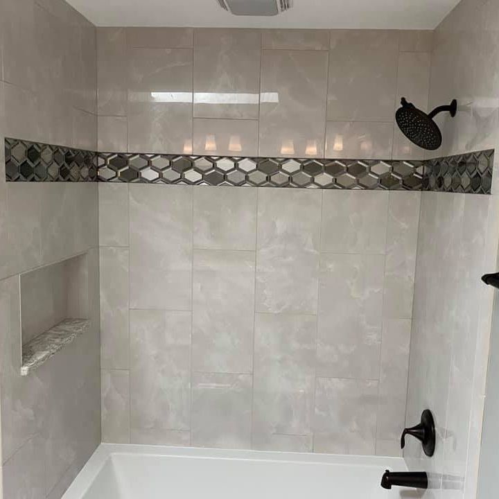 A & R Home Services remodel  bathroom with a bathtub and a shower head.