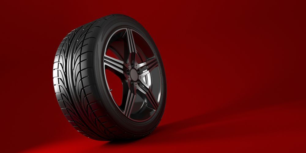 A Close Up Of A Car Alloy Wheel On Red Background — Carite Auto Repairs In Warana, QLD