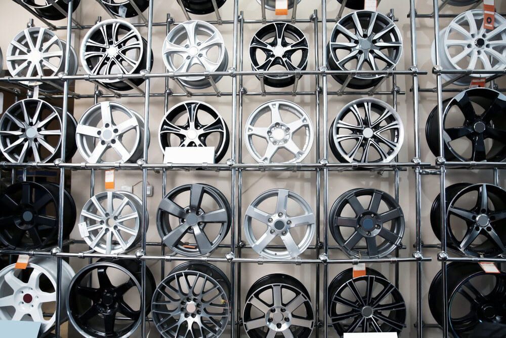 A Wall Filled With A Variety Of Wheels And Tires — Carite Auto Repairs In Warana, QLD