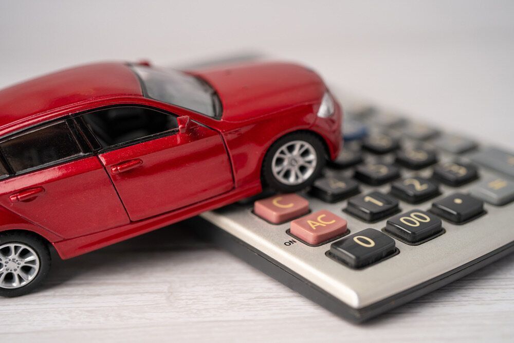 A Red Toy Car Is Sitting On Top Of A Calculator — Carite Auto Repairs In Warana, QLD
