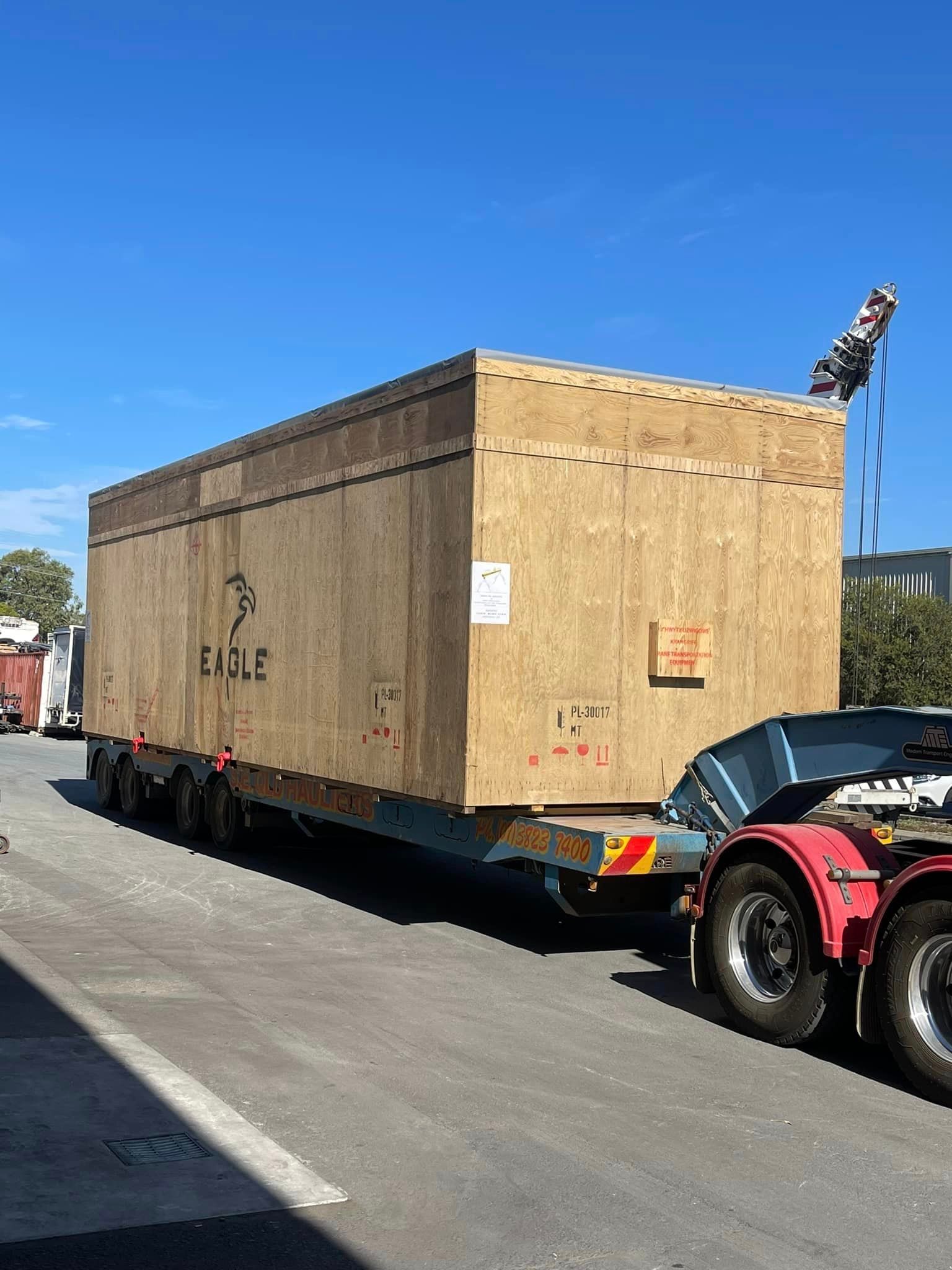 A Truck Is Carrying A Large Wooden Box On A Trailer – Wacol, QLD - Morgan Metal Corp