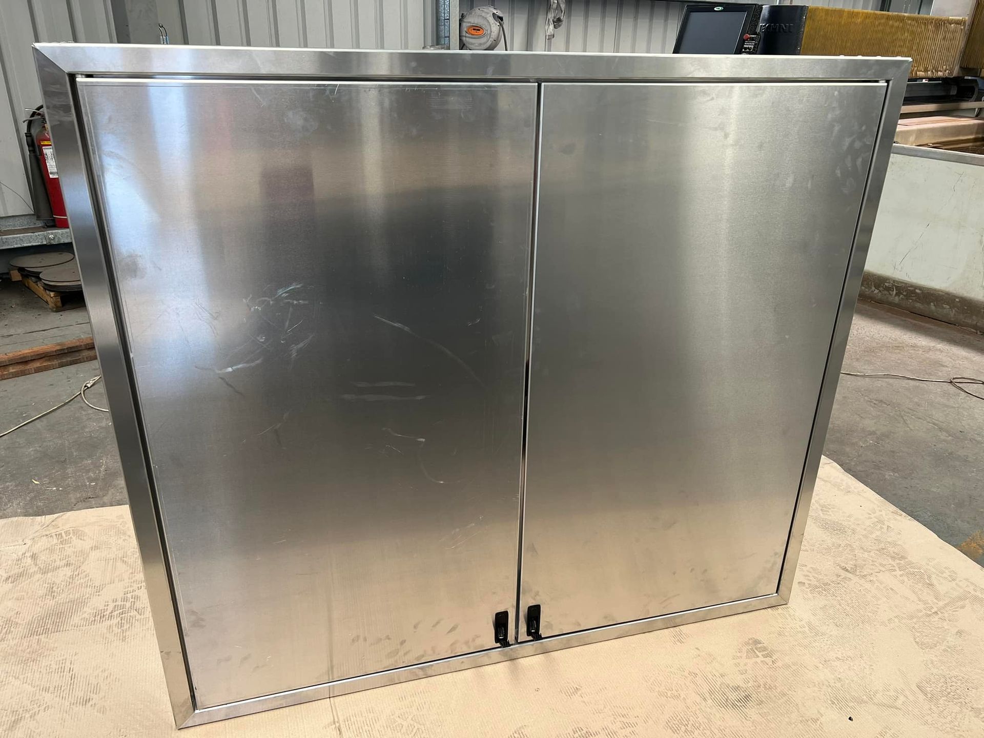 A Stainless Steel Cabinet Is Sitting On Top Of A Wooden Table – Wacol, QLD - Morgan Metal Corp