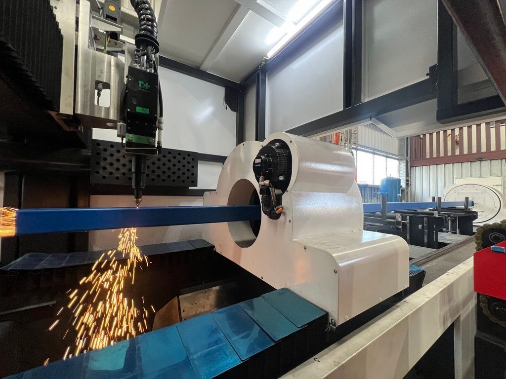 A machine is cutting a piece of metal in a factory.