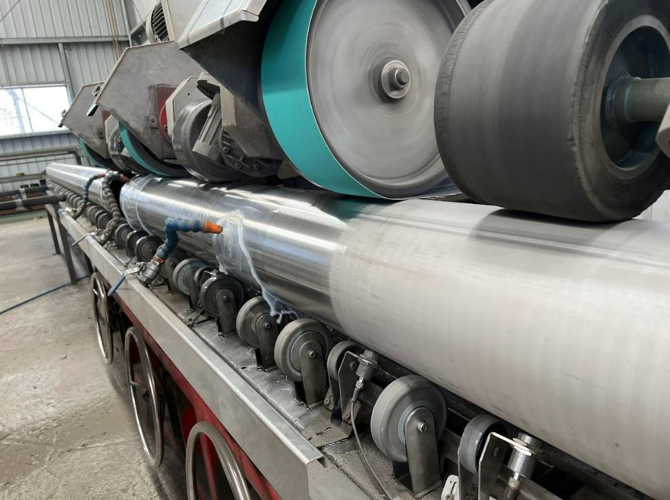 A machine is sitting on top of a conveyor belt in a factory.