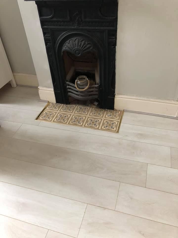 Laminate floor fitted around a fireplace in Cinderhill, Nottingham 