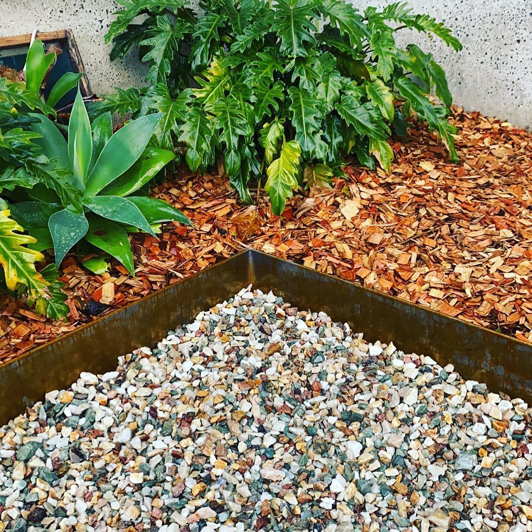 Corner Garden Bed With Gravel, Wood Chips — Manning Valley Landscapes in Old Bar, NSW