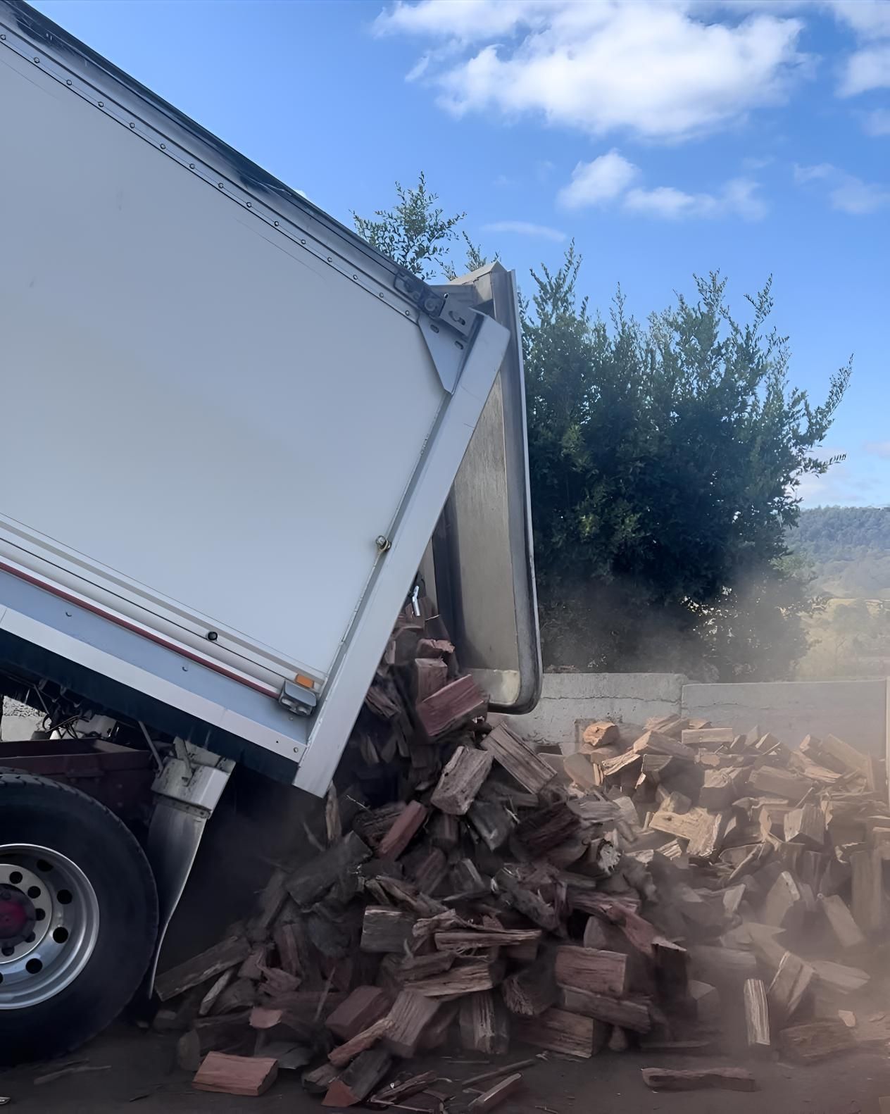 A Truck is Dumping a Pile of Wood Into the Ground — Manning Valley Landscapes in Wingham, NSW