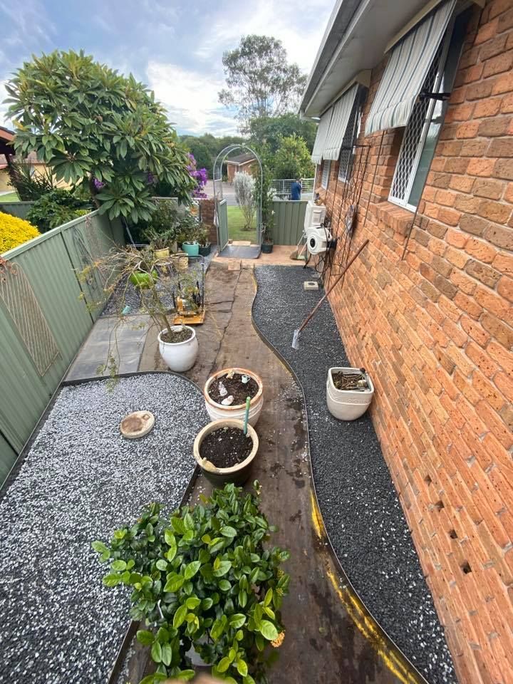 Narrow Backyard Path Lined With Brick Wall, Gravel — Manning Valley Landscapes in Wingham, NSW