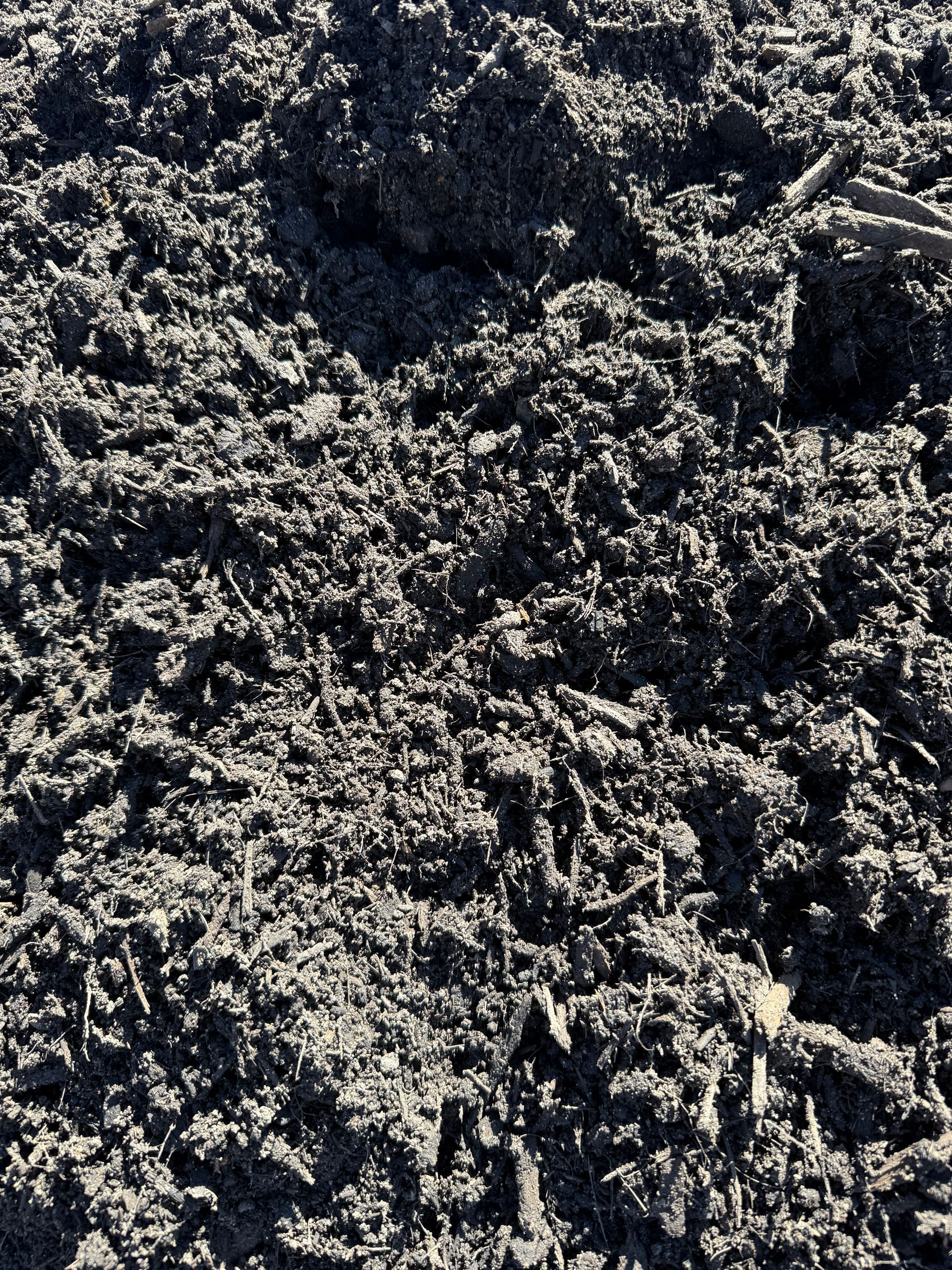 Dark Mulch, with Visible Wood Chips and Organic Matter — Manning Valley Landscapes In Wingham, NSW