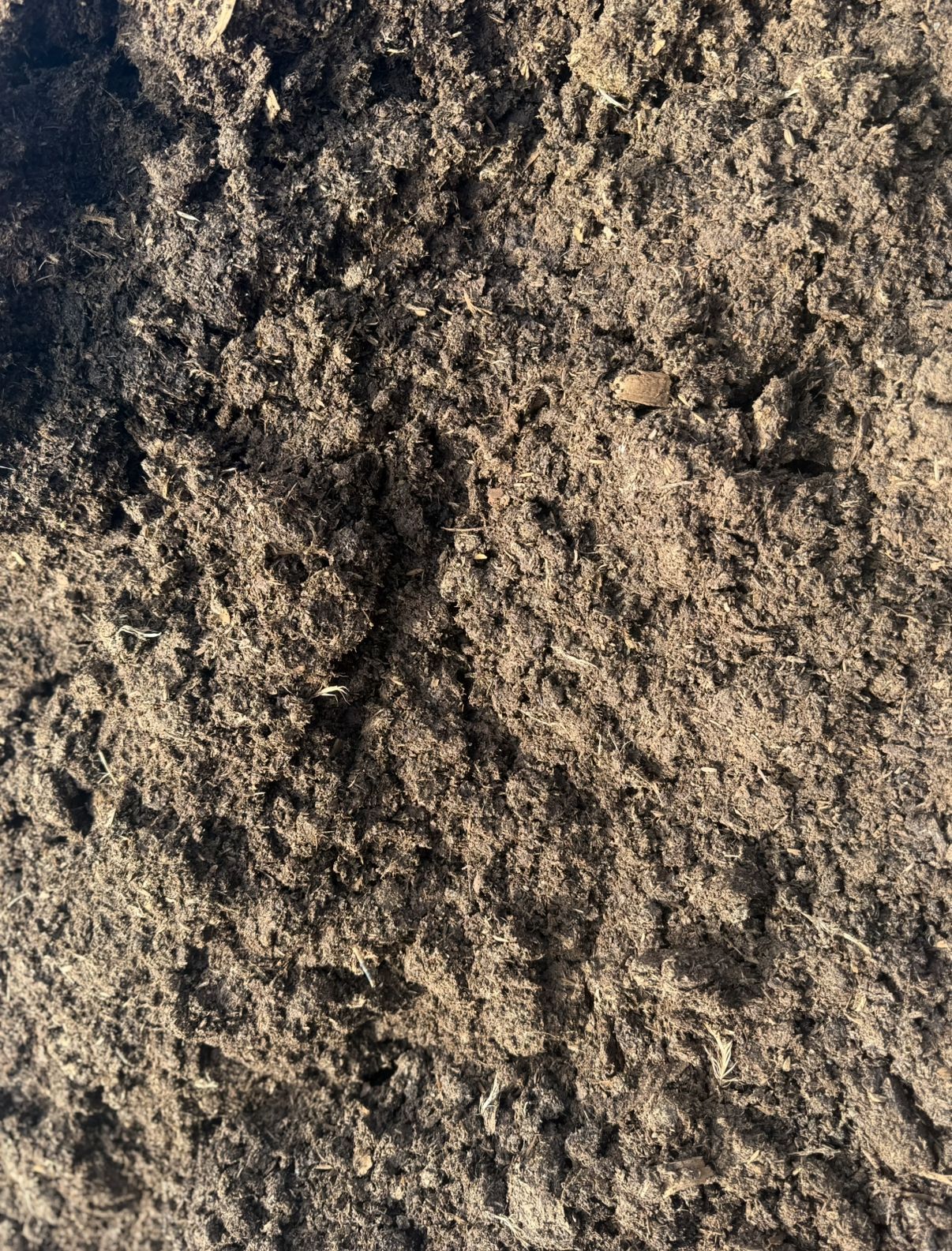 Close-Up of Dark Brown Soil, Likely Compost or Topsoil — Manning Valley Landscapes In Wingham, NSW