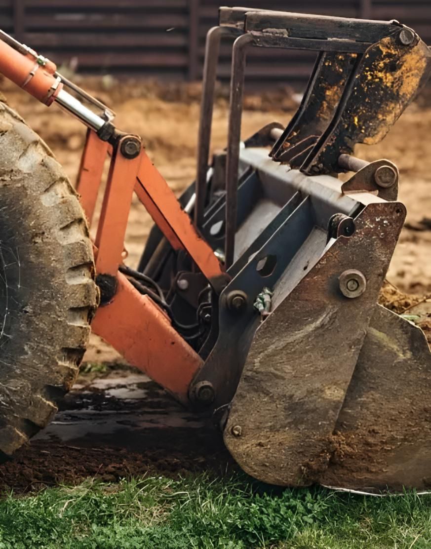 A Bulldozer is Sitting on Top of a Grass Covered Field — Manning Valley Landscapes in Wingham, NSW