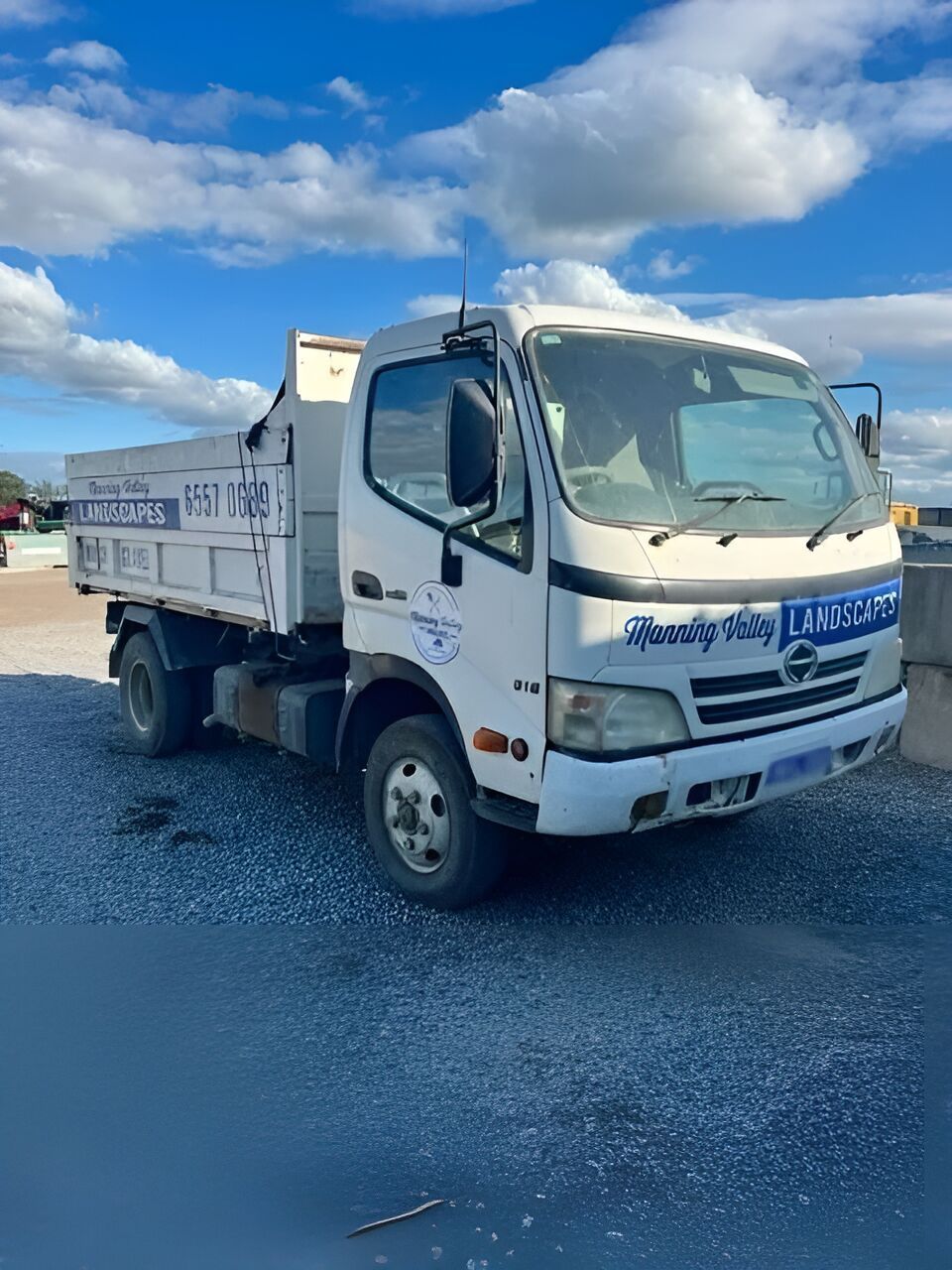 A White Dump Truck is Parked on a Gravel Road — Manning Valley Landscapes in Wingham, NSW
